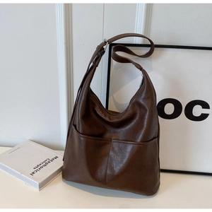 Detail view of deep brown leather hobo bag with adjustable strap and silver metal buckle