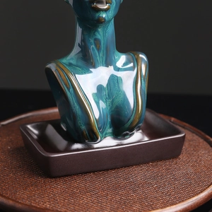 Abstract ceramic woman statue incense burner with blue-green glaze on woven mat