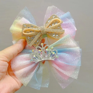Close-up of mesh rainbow hair clips with sparkling rhinestone crown and bow for girls