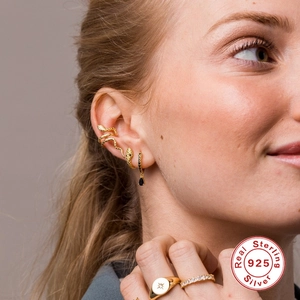 Detailed view of S925 sterling silver gold snake cuff and black gem drop earring set