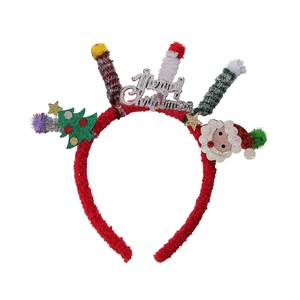 Detail of red plush Christmas headband with Merry Christmas text and festive ornaments