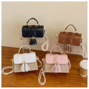 Detail of four woven straw handbags with fringe tassels and cotton rope straps in four colors