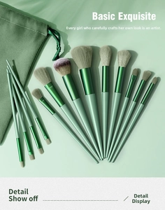 Detailed set of 13 professional makeup brushes with mint green handles and soft storage pouch