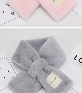 Detailed view of soft faux rabbit fur plush scarves in pink and gray with brand labels