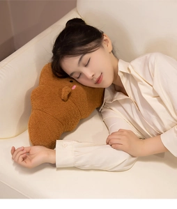 Soft croissant plush pillow shown in a cozy home setting for sleeping comfort