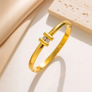 Minimalist gold-plated stainless steel open bangle featuring two sparkling zircon stones