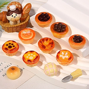 Vue macro détaillée de mini tartes aux œufs en résine et panier à pain chat