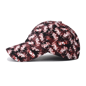 Side view of a creative baseball cap featuring a red, white, and black abstract camo pattern