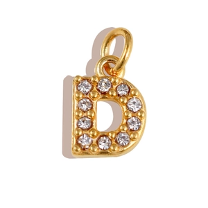 Detail of gold letter D pendant featuring embedded sparkling white zircon stones