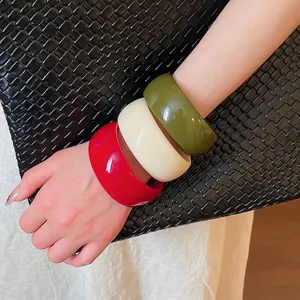 Minimalist geometric acrylic bangles in red, off-white, and olive green for women