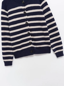 Detailed macro view of horizontal stripes and navy buttons on knit cardigan