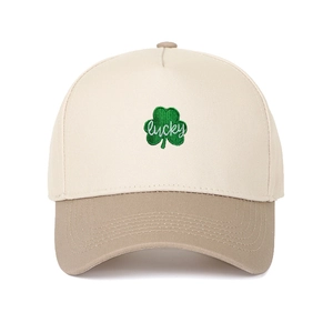 Detailed view of green shamrock embroidery with lucky text on off-white trucker cap