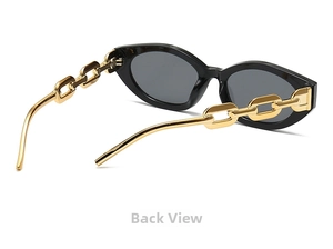Detail of vintage cat-eye sunglasses featuring chunky gold metal chain temples and black frame