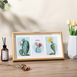 Nordic wooden triple photo frame with cactus prints on a sunlit wooden desk