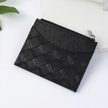 Top view of black woven texture mini wallet with zipper closure on a white surface