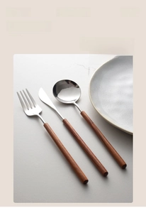 Detail view of mirror polished 304 stainless steel cutlery set with long wood handles