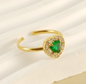 Close-up of 18K gold ring featuring a green heart-shaped gemstone with zircon halo