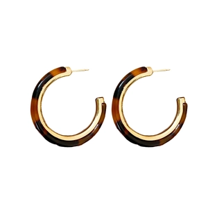 Vintage tortoiseshell resin C-shaped hoop earrings with polished gold metal inner lining