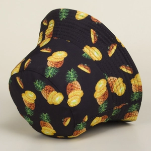 Detail of black cotton bucket hat featuring vibrant yellow and green pineapple prints