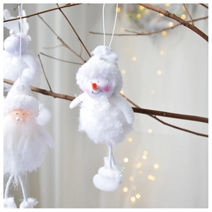 Close-up of plush white Santa and reindeer ornaments hanging on branches with bokeh light