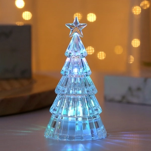 Close-up of crystal LED Christmas tree light with blue glow and warm bokeh background