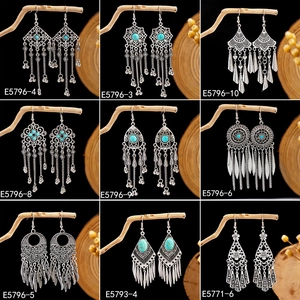 Detailed grid of nine Bohemian tribal earrings with turquoise stones and vintage silver finish