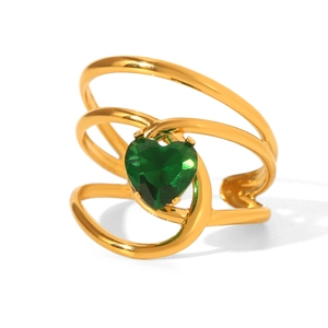Close-up of triple-layered gold ring featuring a green heart-shaped gemstone center