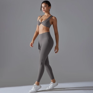 Two-piece dark grey workout set featuring a twist-front sports bra and high-waist leggings