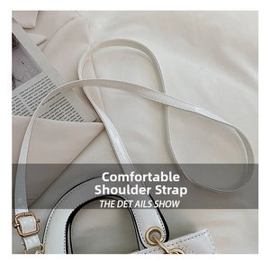 Detail view of the quilted white leather handbag and adjustable shoulder strap