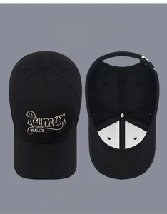 Detail of embroidered lettering and adjustable silver metal buckle on a black baseball cap