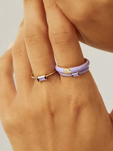 Detail of purple enamel ring set with 18k gold plating and square zircon stones