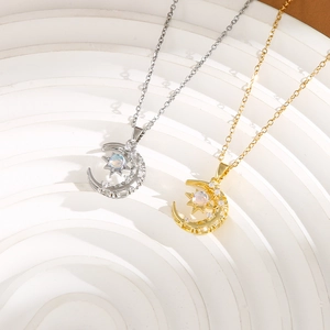 Detailed view of gold and silver star and moon pendants with opals on white stairs