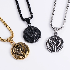 Detailed view of oval snake head pendants in gold, black, and silver stainless steel