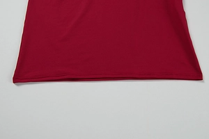 Detailed view of the hem stitching on a premium burgundy red long-sleeve dress