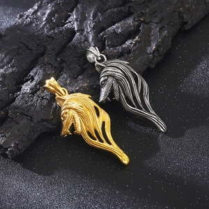 Detail of vintage Viking wolf head pendants in polished gold and silver metal finishes