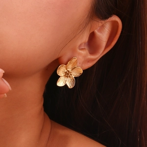 Detailed view of 18K gold plated flower stud earrings with intricate petal texture