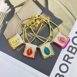 Handmade religious bracelets with colorful Virgin Mary pendants and gold snake chains