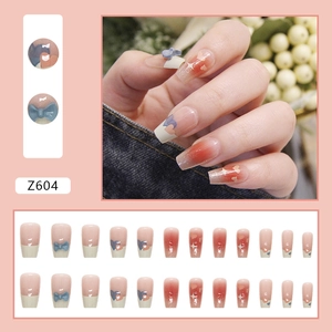 Pink blush press-on nails with blue bows and white heart details, 24 pieces set