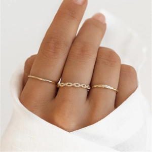 Close-up of three gold S925 silver rings with zircon accents on a model's hand