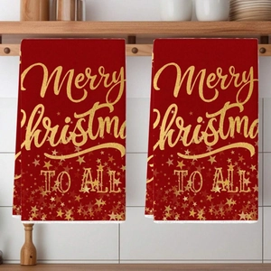 Set of two red Merry Christmas kitchen towels with golden star patterns and text