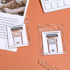 Close-up of heart and paw print decorative metal rings for silicone watch straps