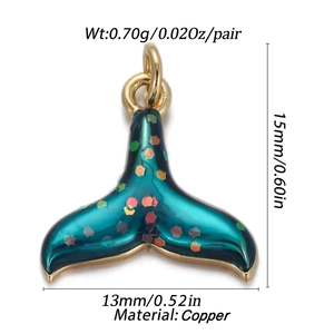 Macro view of whale tail pendant with blue enamel, copper material and dimensions