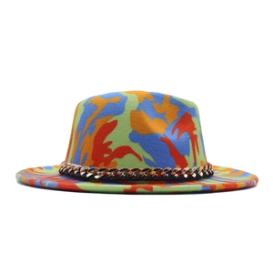 Detail of colorful graffiti fedora with gold metal chain trim and abstract patterns