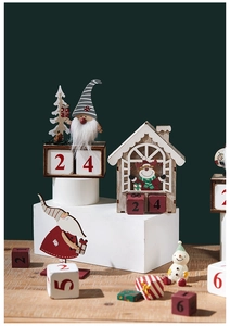 Detail of wooden Christmas countdown calendar with Santa, snowman and numbered cubes