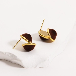 Detail of 18K gold plated earring featuring a rich dark brown flocked suede sphere on stone