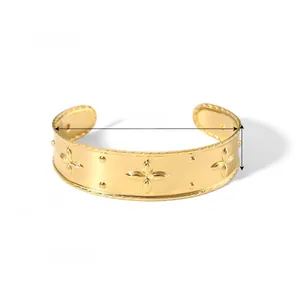 Detail of 18K gold-plated cuff bracelet featuring floral relief and 19.6mm width details