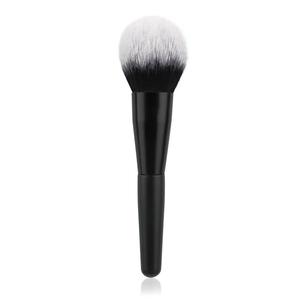 Close-up of dual-tone flame-shaped synthetic bristles on a matte black makeup brush