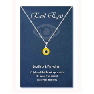 Detail of yellow Evil Eye pendant on silver chain with protection blessing card