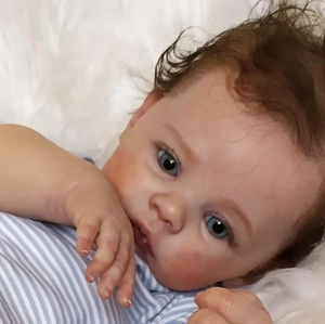 Lifelike 49cm reborn baby doll Meadow with 3D skin, blue eyes and brown hair detail