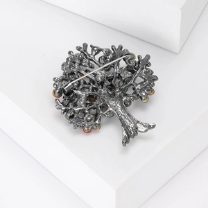 Macro detail of alloy Tree of Life brooch with colorful crystals and back pin design